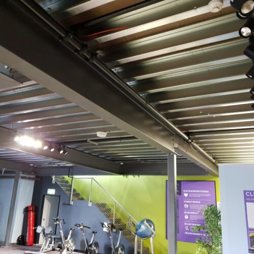 Commercial mezzanine floor for Anytime Fitness facility, expanding usable floor area.