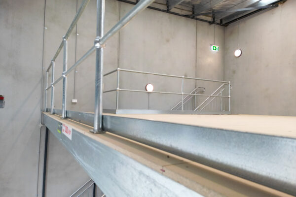 Industrial raised storage area for Modular Mezzanine Floor System for Industrial Developments. - Dynamic Warehouse Solutions installation showcasing integrated mezzanine office spaces